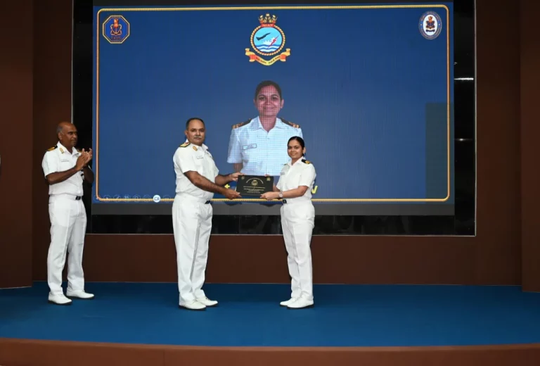 Rear Admiral Anshuman Chauhan Giving Award to Female Officer